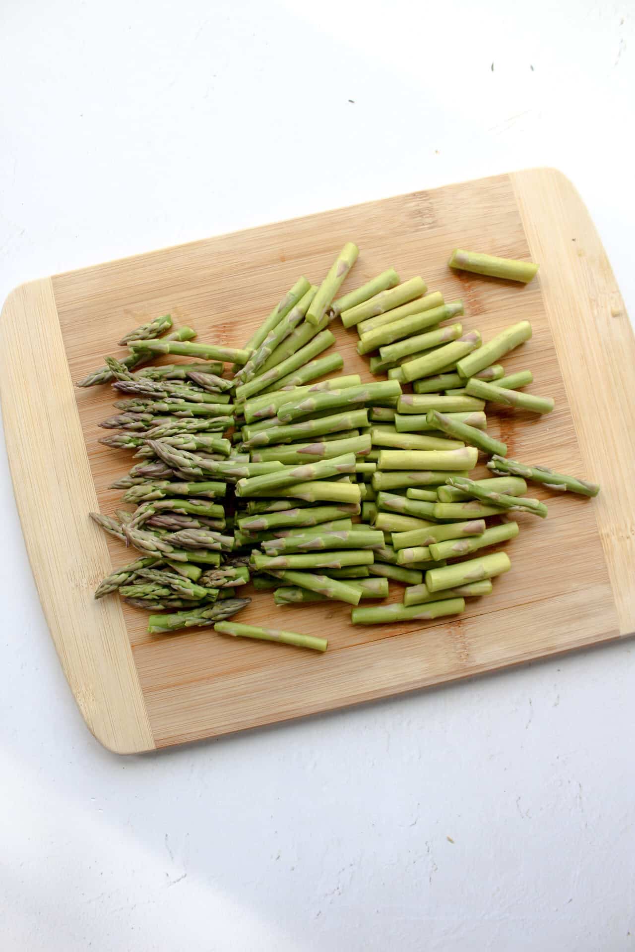 Chopped asparagus on a cutting board.