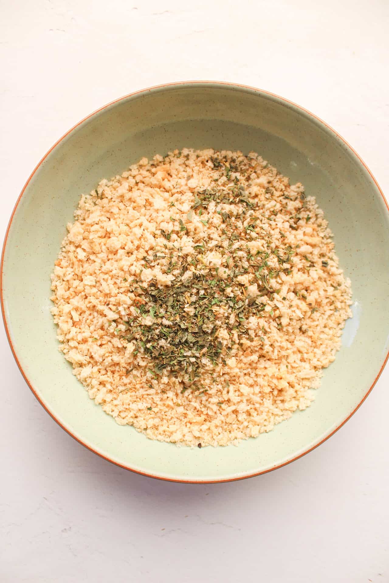 Panko breadcrumbs in a large bowl with italian seasoning.