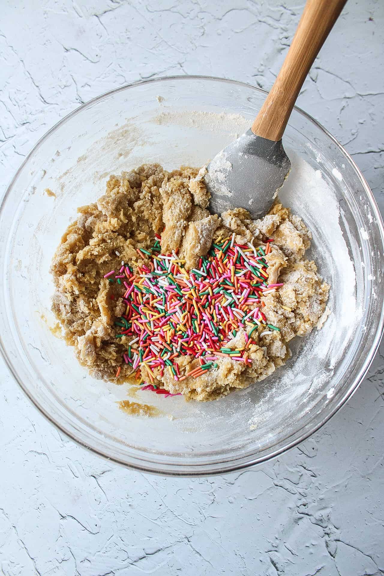 Blondie batter in a large bowl with sprinkles.
