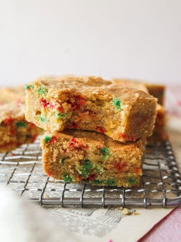 two funfetti blondies on top of each other with one missing a bite.
