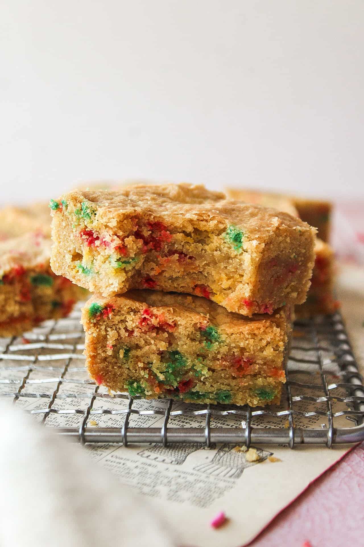 two funfetti blondies on top of each other with one missing a bite.