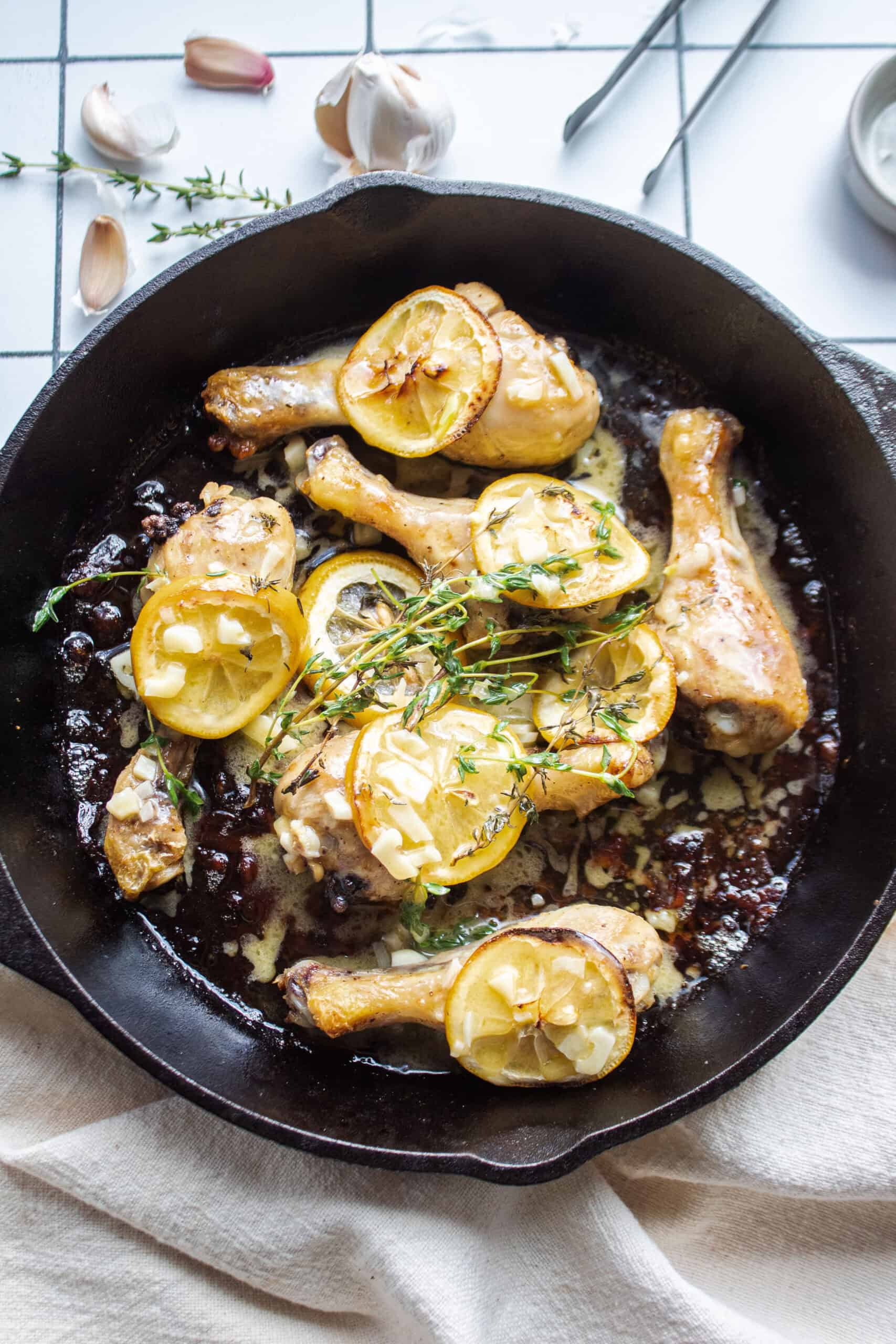 skillet roasted lemon chicken drumsticks in a cast iron pan.