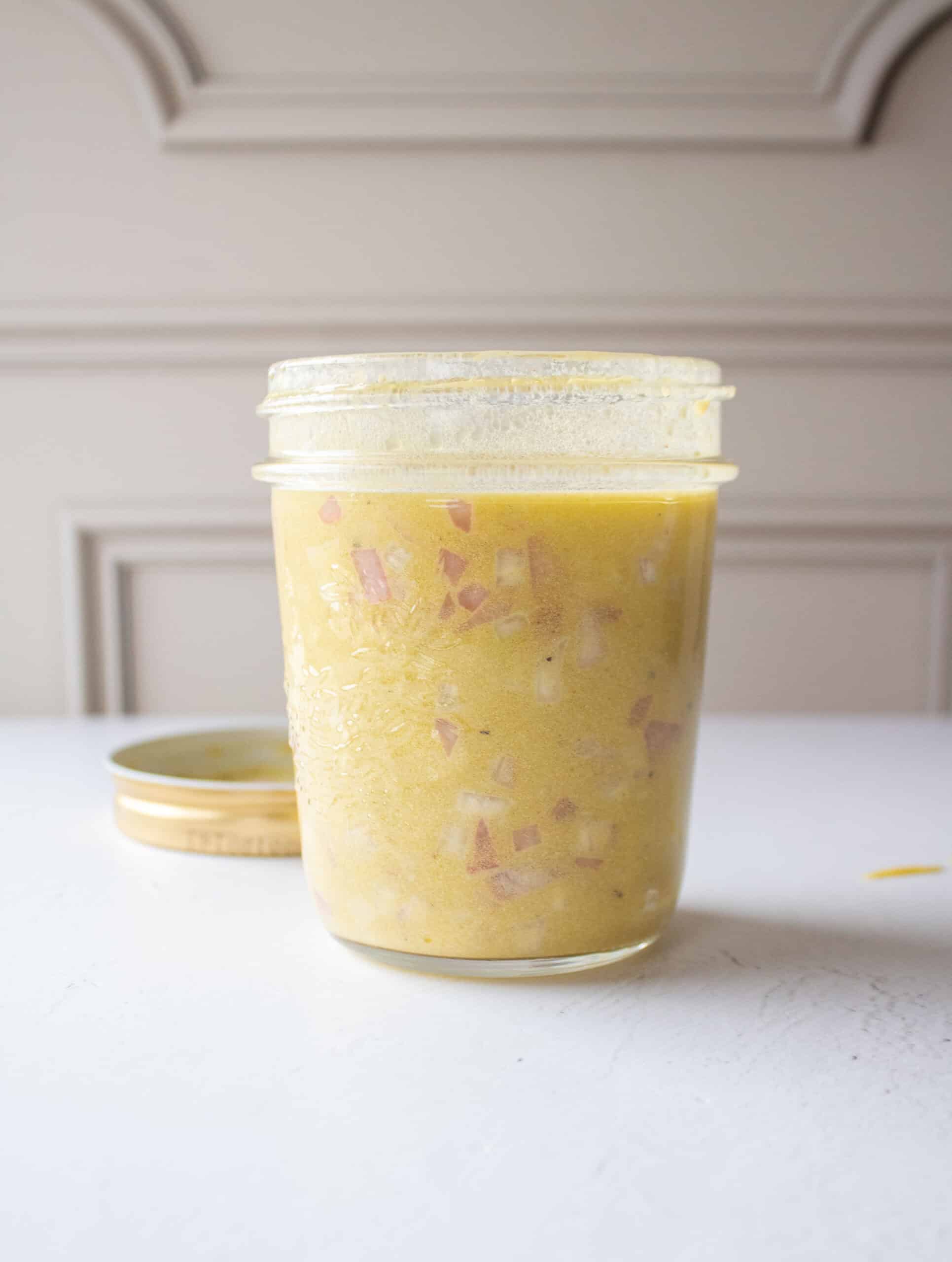 shallot, dijon mustard, olive oil, and white wine vinegar added to a mason jar.