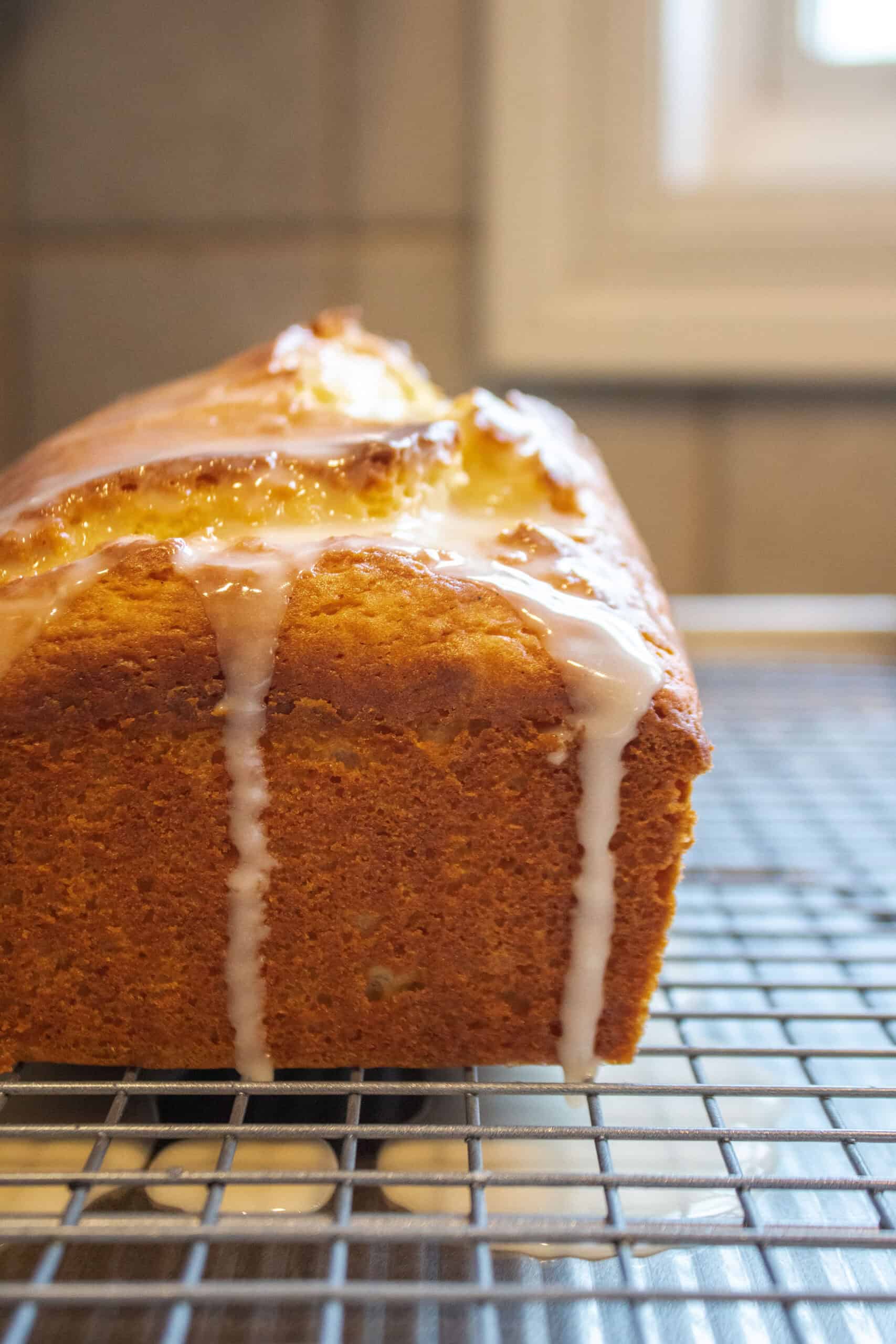 glazed lemon loaf cake on a cooling rack.