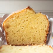 A loaf of lemon pound cake in a white dish