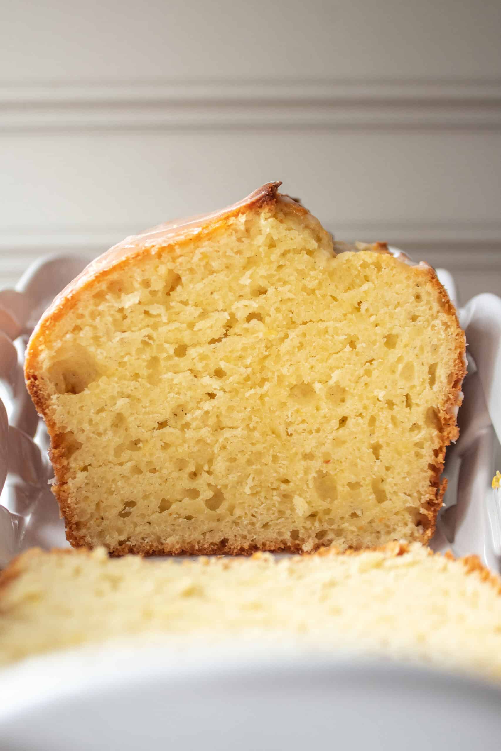 A loaf of lemon pound cake in a white dish