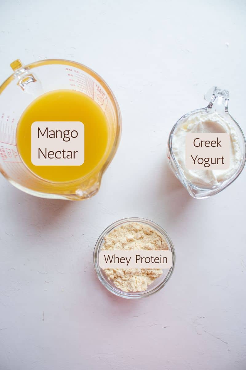 Ingredients to make high protein mango yogurt popsicles.