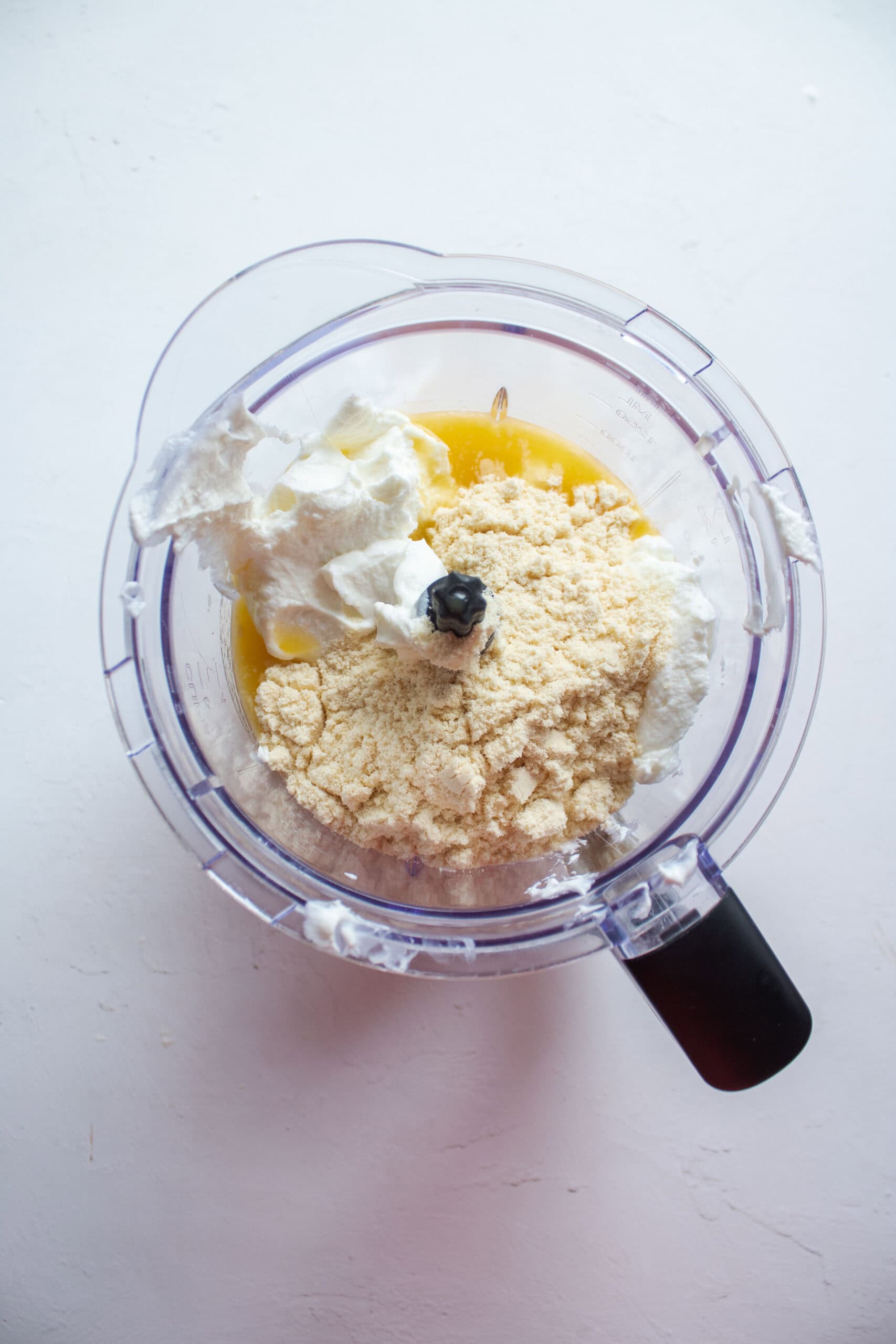 greek yogurt, mango nectar, and whey protein powder in a blender.