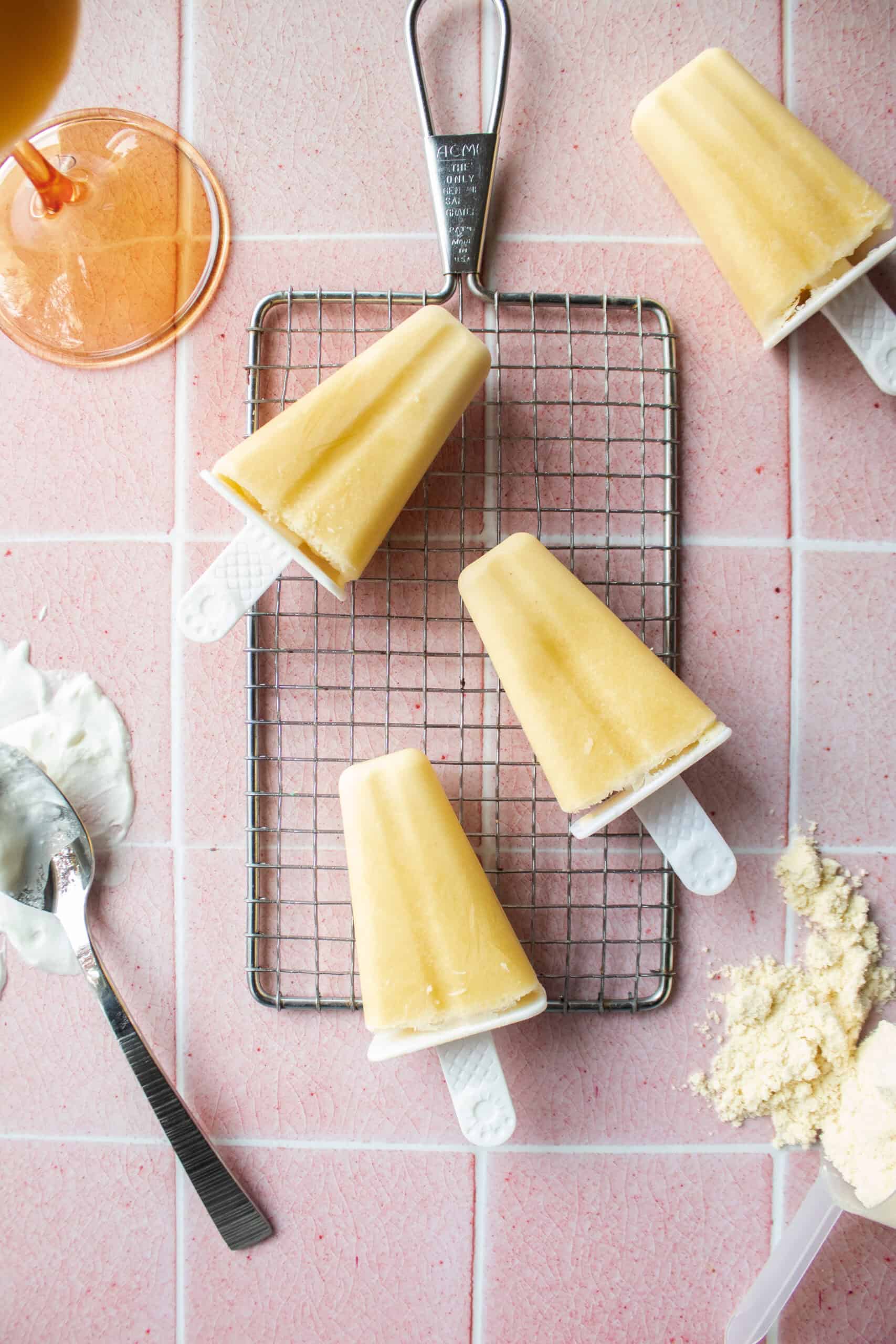 mango yogurt popsicles on a cooling rack.
