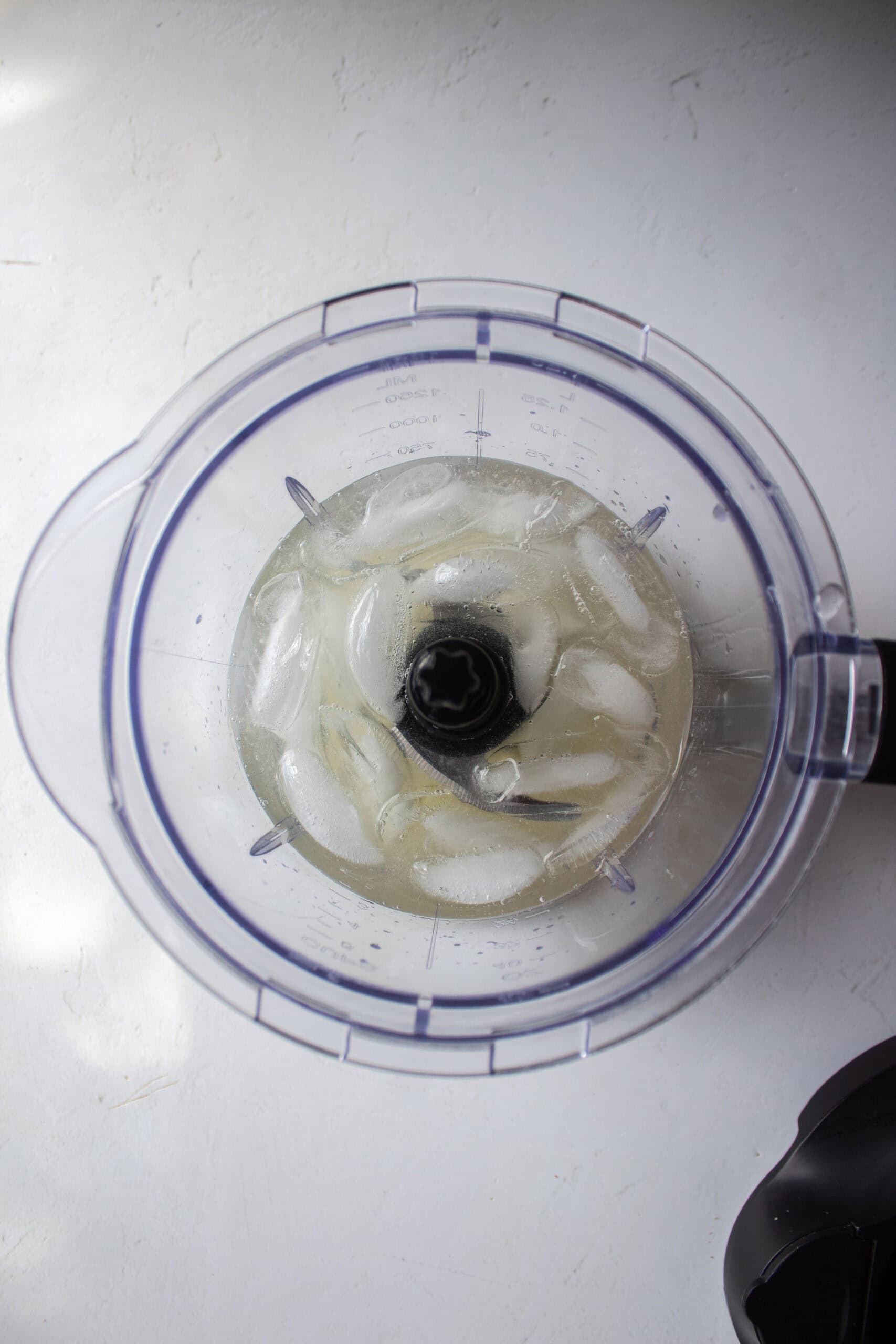 Ice in a blender with prosecco, gin, and lemon juice,