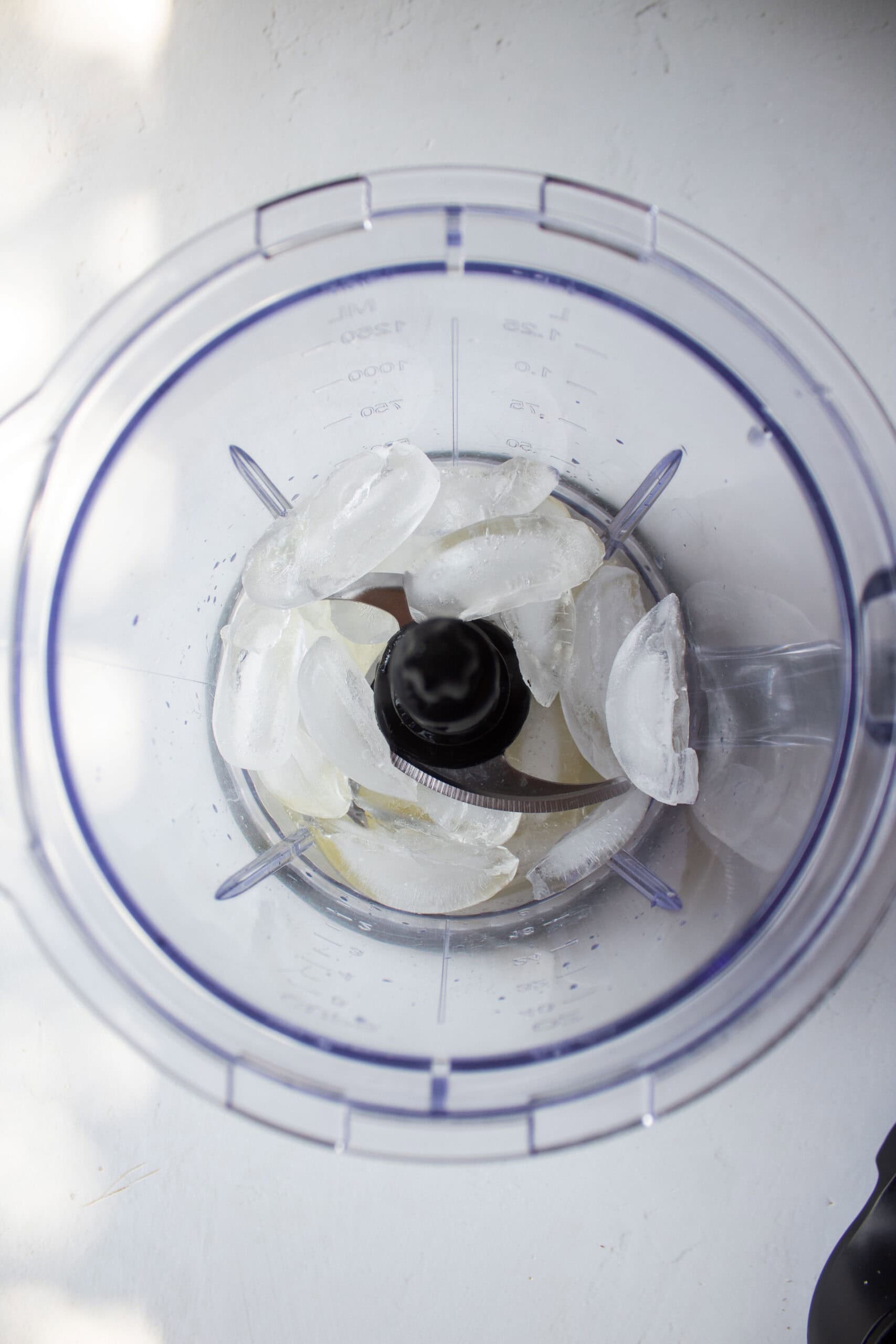 Ice in a blender with fresh lemon juice.