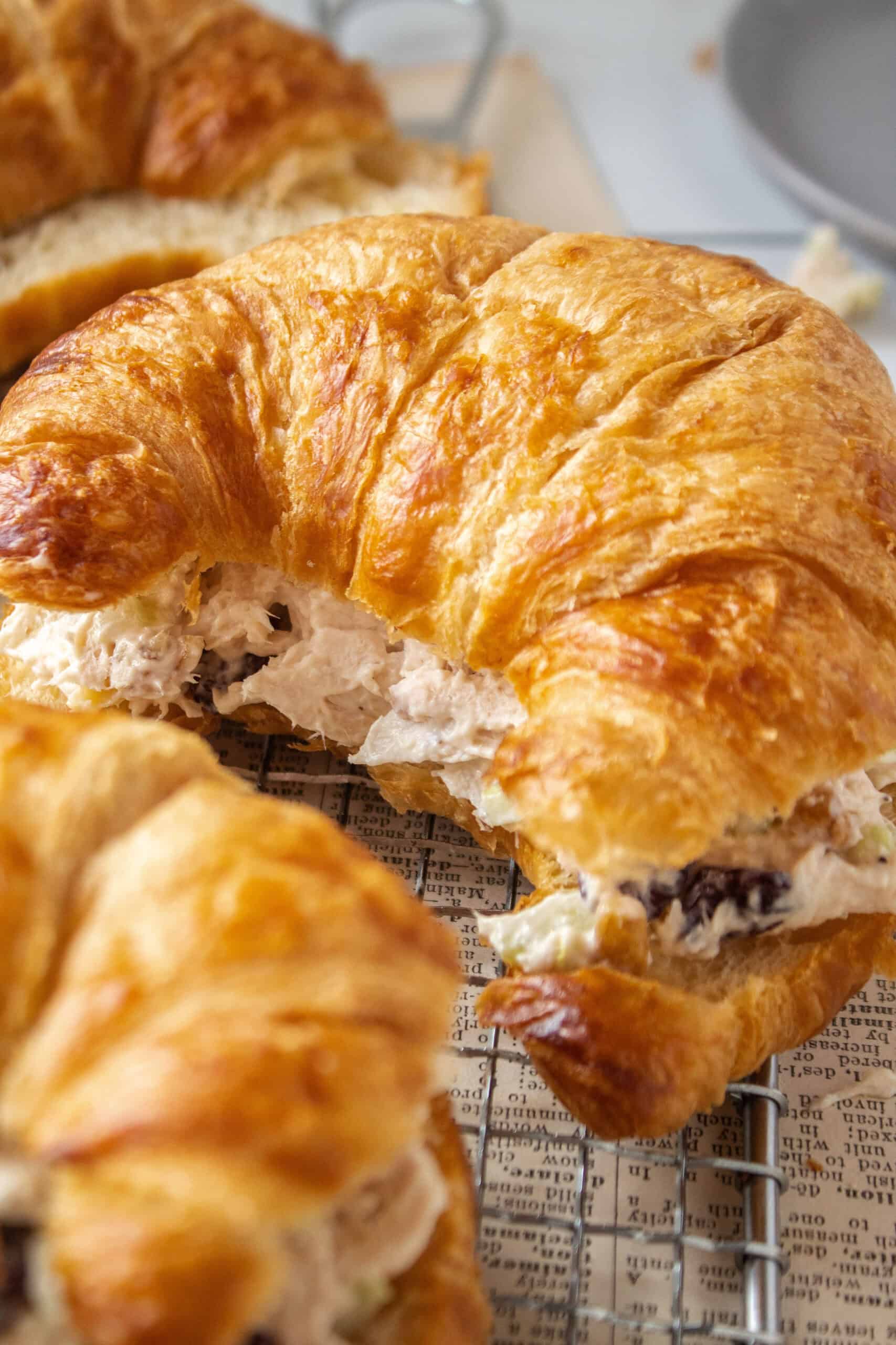 Middle croissant close up with chicken salad inside.