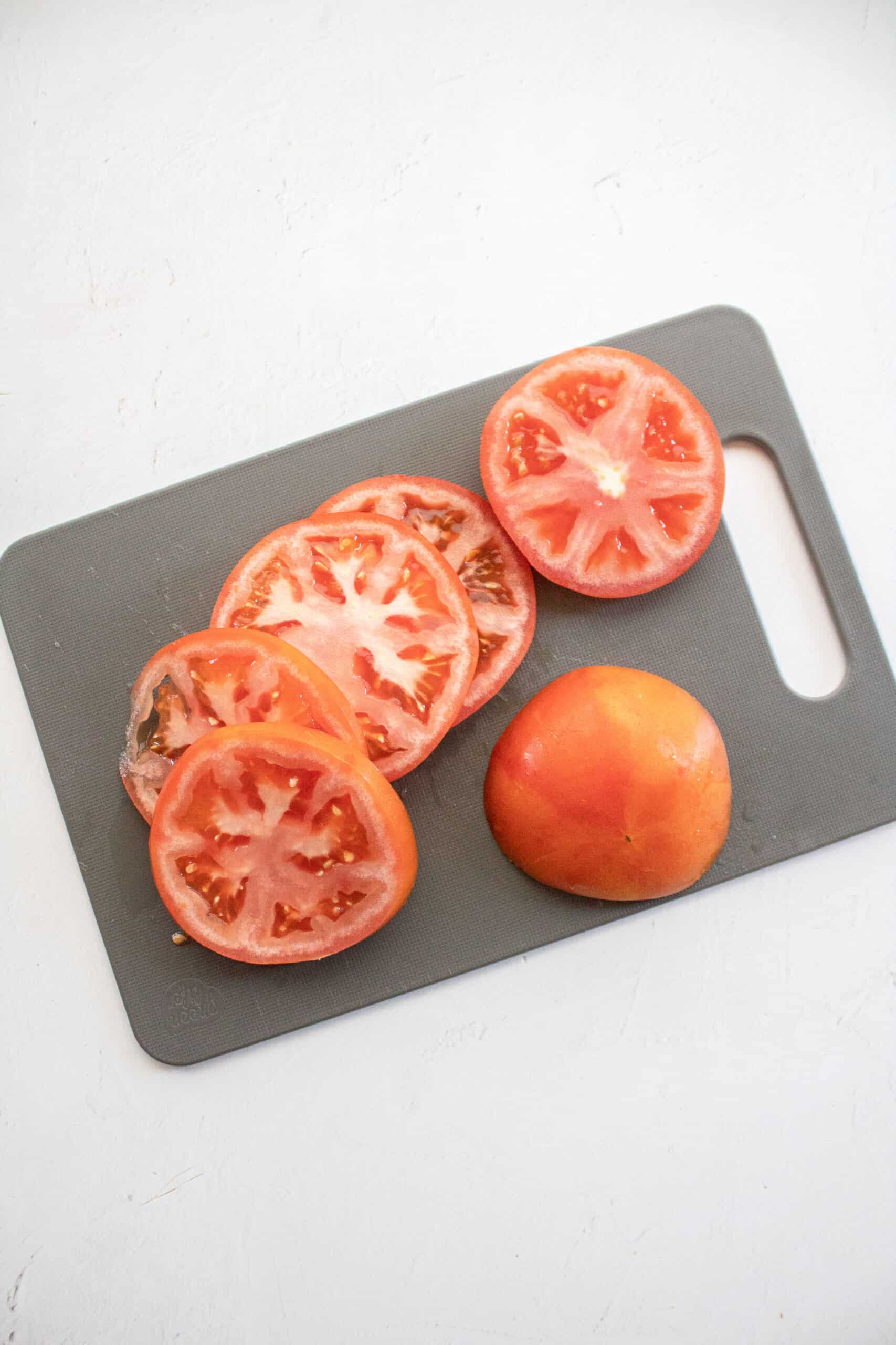 Sliced tomato on a cutting board.