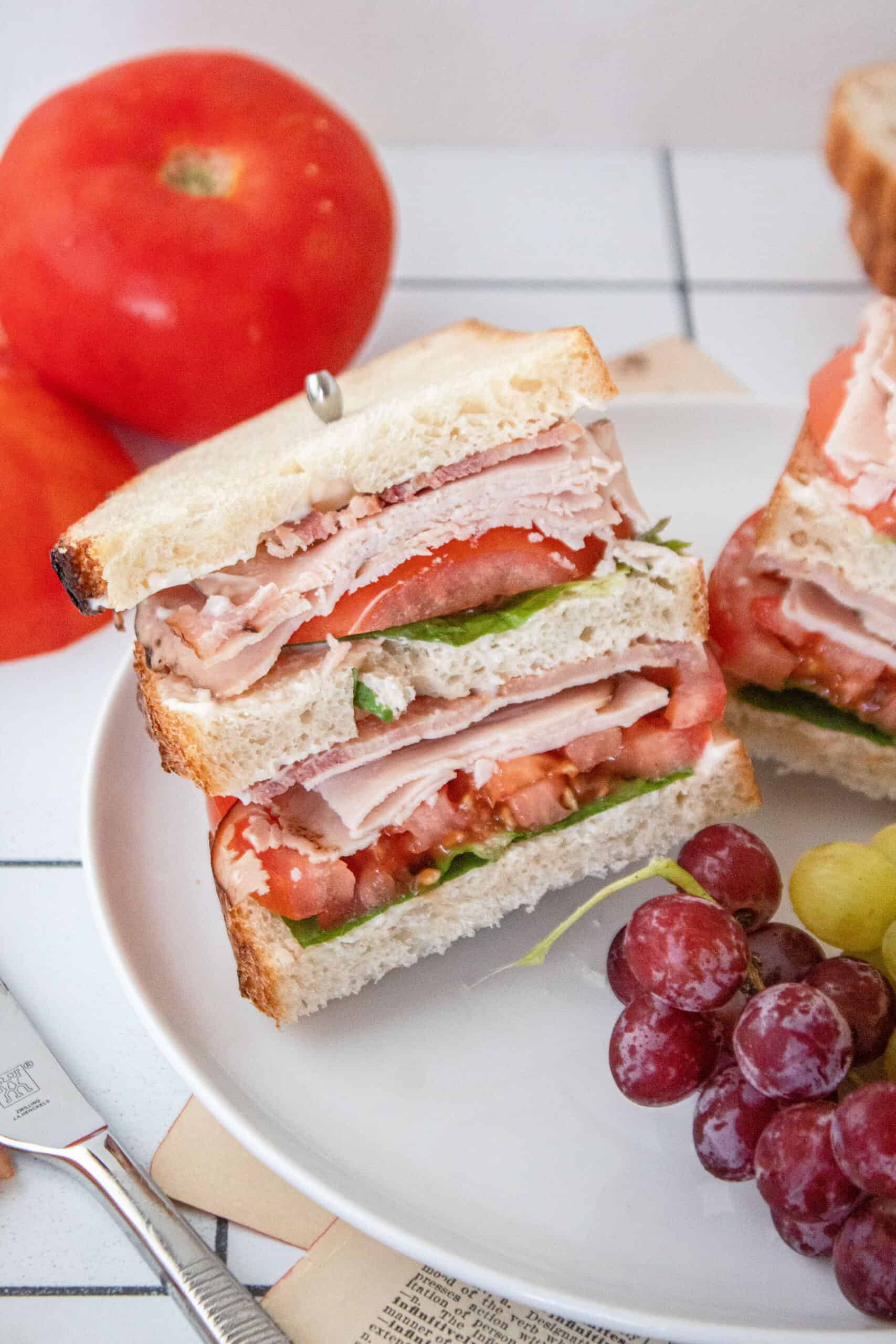 A turkey club sandwich on a plate.