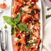 Watermelon salad with feta and mint on a plate with balsamic drizzled on top.