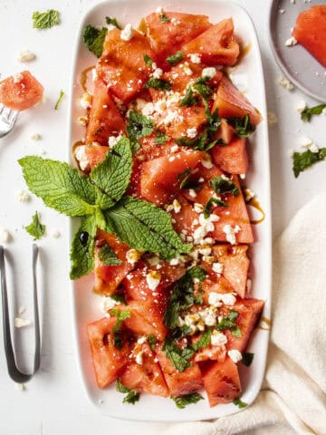 Watermelon salad with feta and mint on a plate with balsamic drizzled on top.