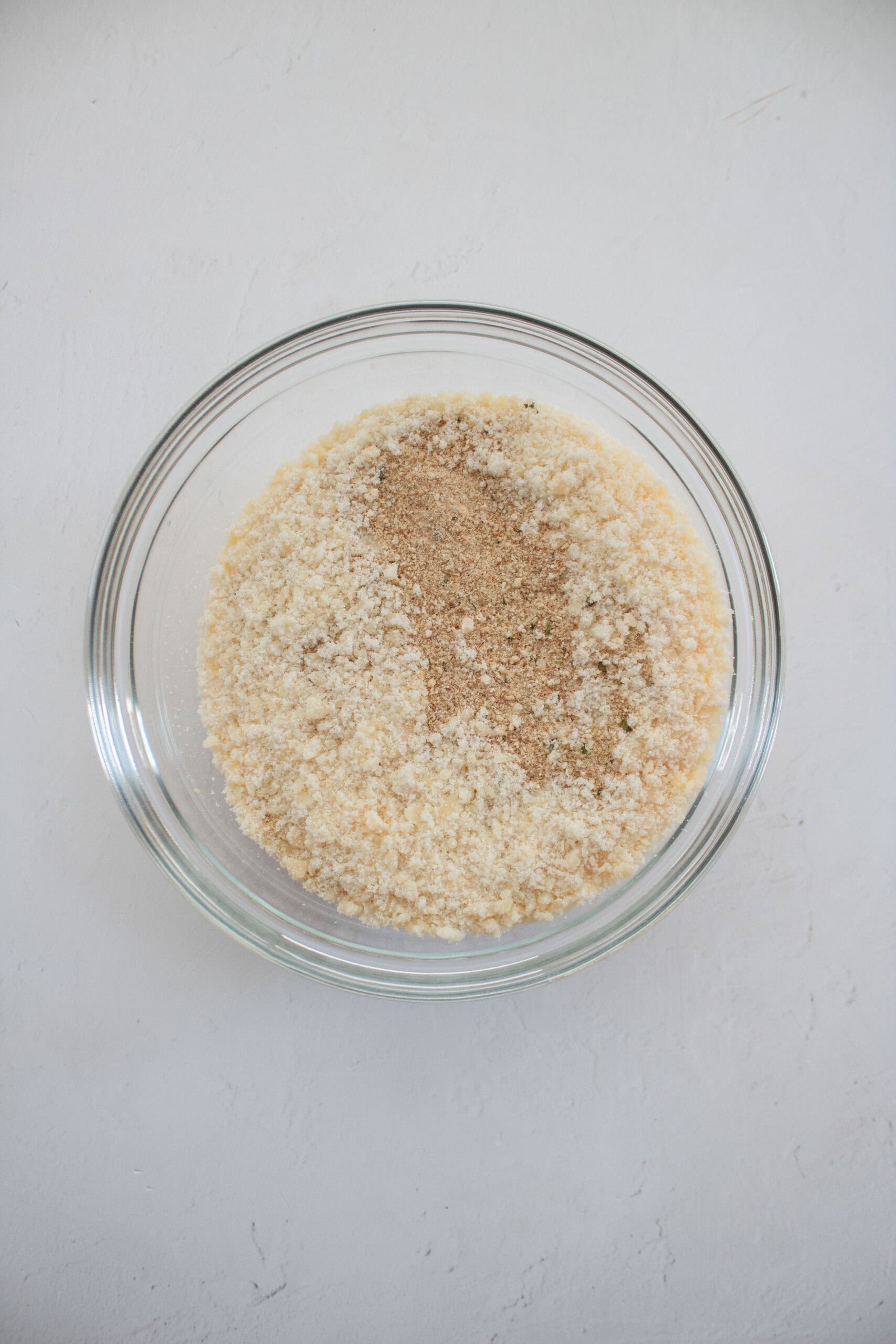 Breadcrumbs, garlic powder, and parmesan cheese in a mixing bowl.