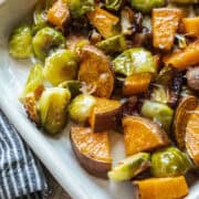 Roasted brussels sprouts and sweet potato in a platter.