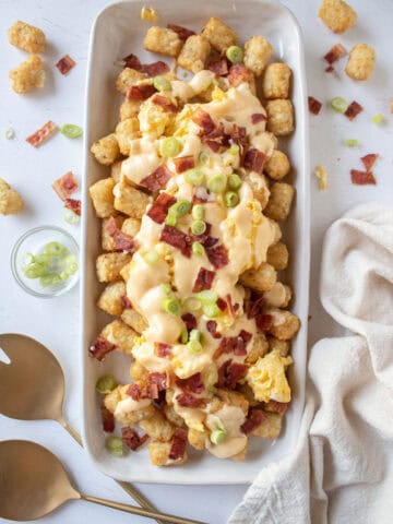 Loaded breakfast totchos with bacon, scallions, eggs, cheese.