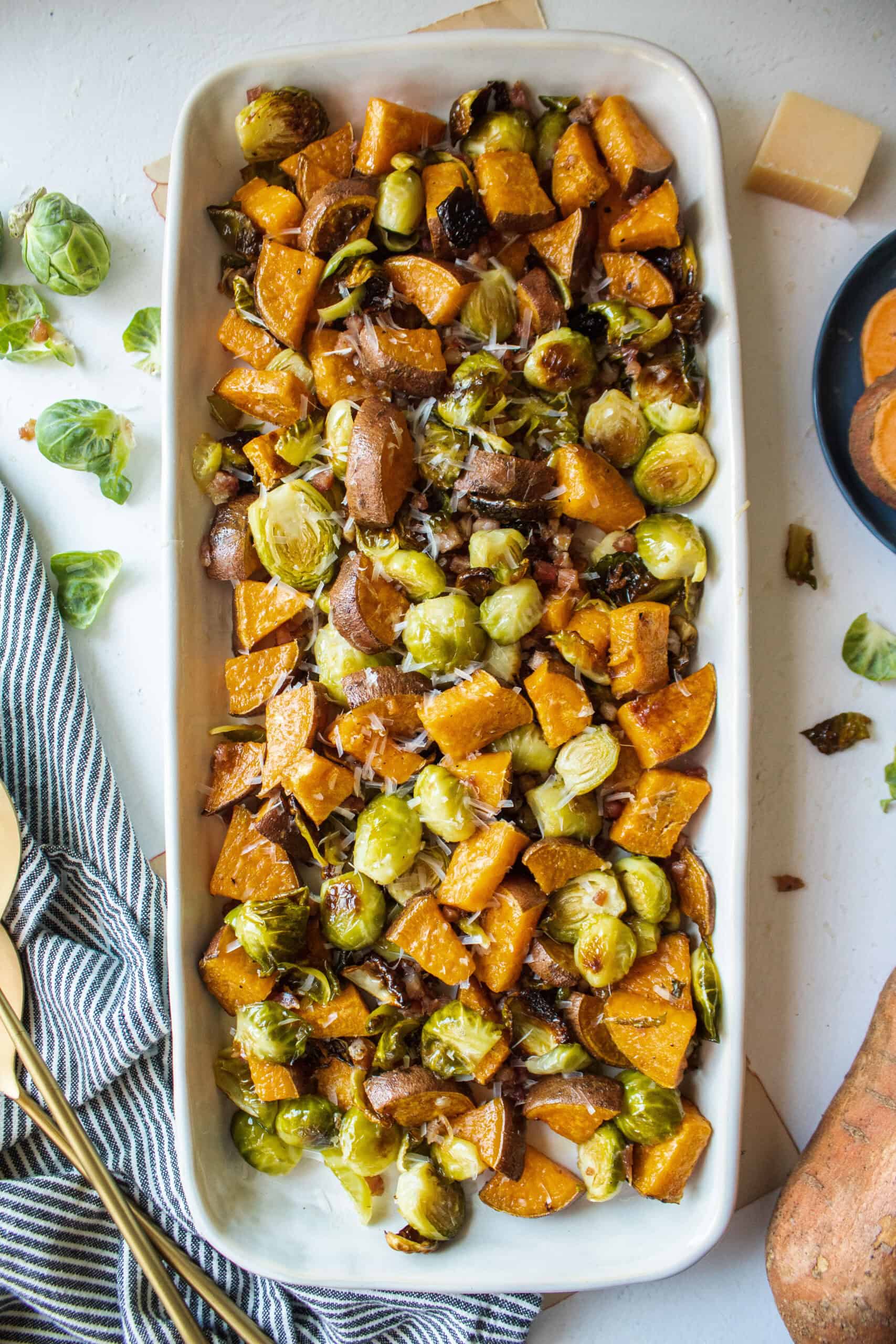 Roasted brussels sprouts and sweet potato in a platter.