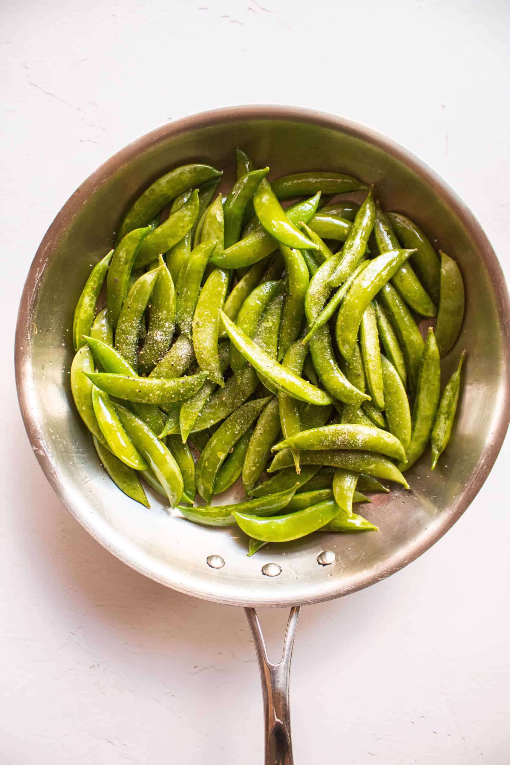 Snap peas in a frying pan with olive oil, salt, and pepper.