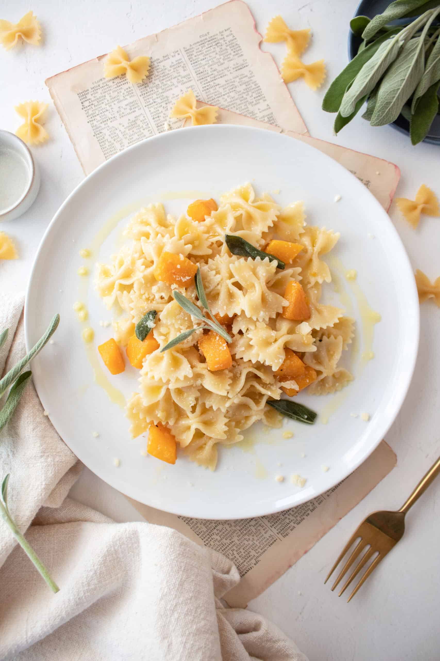 Butternut squash pasta on a plate with butter and sage sauce.