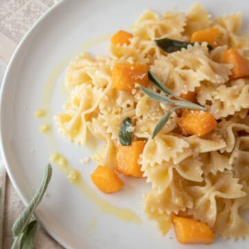 Butternut squash pasta on a plate with butter and sage sauce.