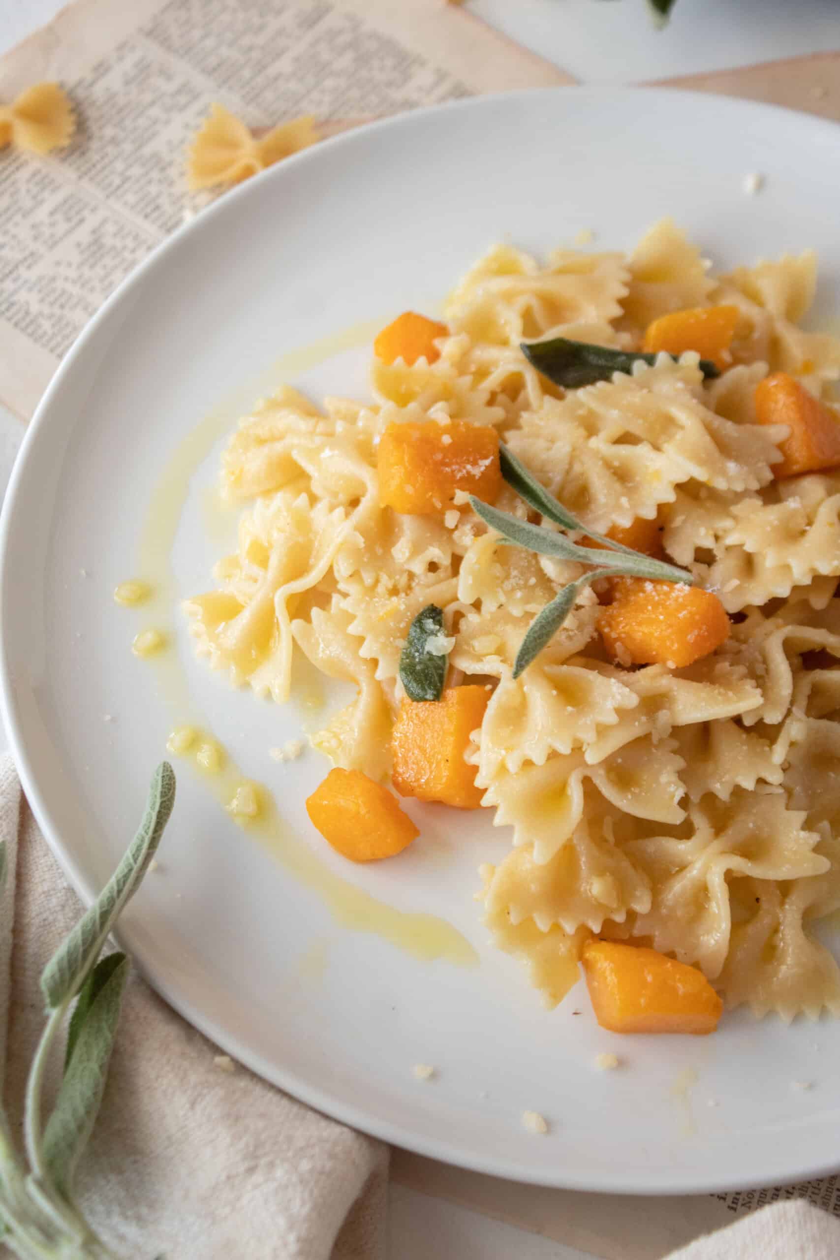 Butternut squash pasta on a plate with butter and sage sauce.