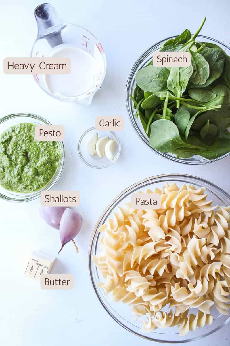 Ingredients needed to make creamy pesto pasta with spinach.