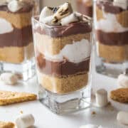 Smores parfaits with graham crackers, pudding, marshmallow cream, topped with toasted marshmallows.