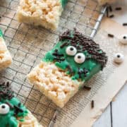 A closeup of a frankenstein rice krispie treat on a cooling rack.