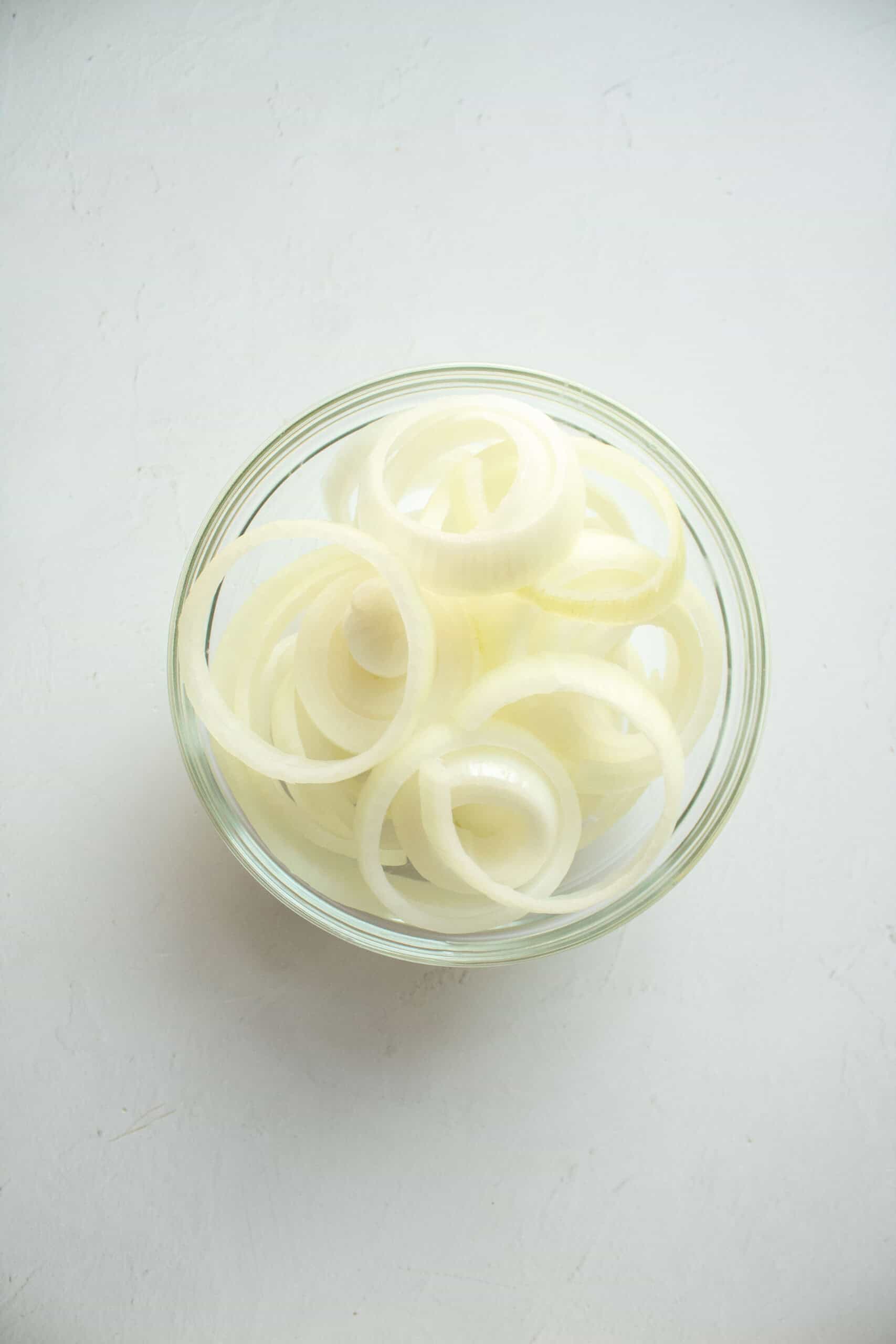 Sliced onions in a small bowl.