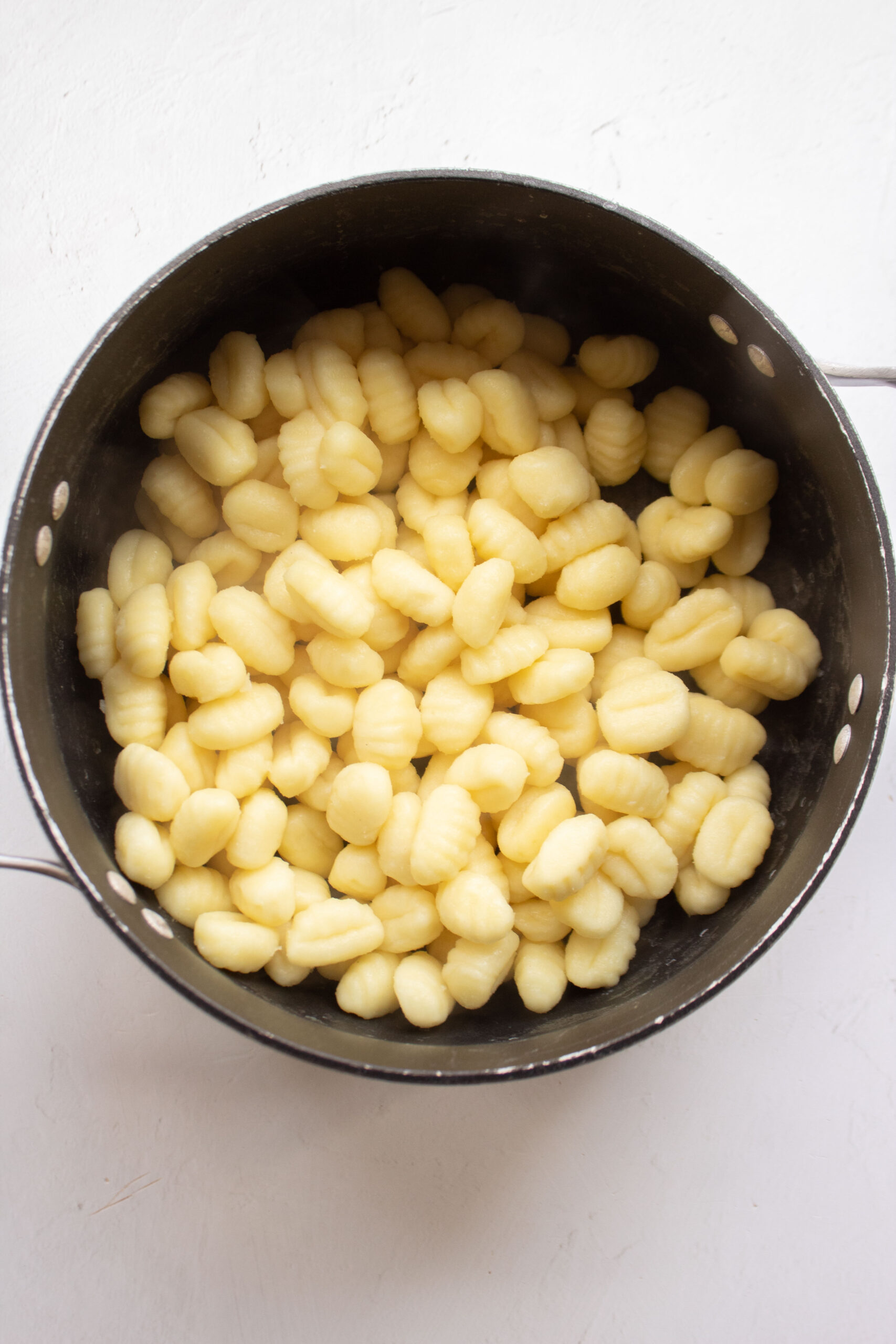 Boiled gnocchi pasta in a large pot.