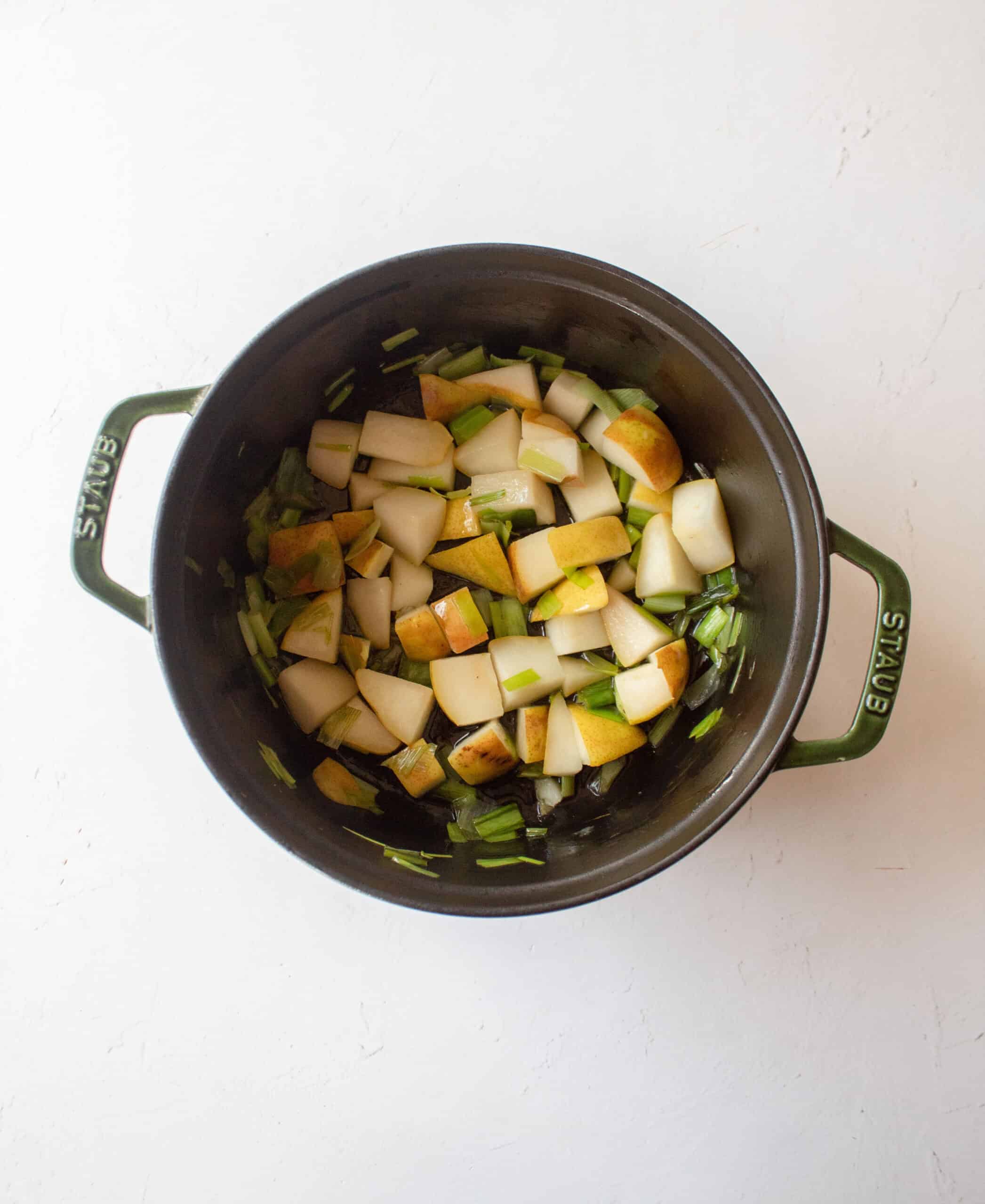 Sauteed leeks with pears in a dutch oven with olive oil.