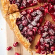 A slice of a cranberry orange galette on a serving board.