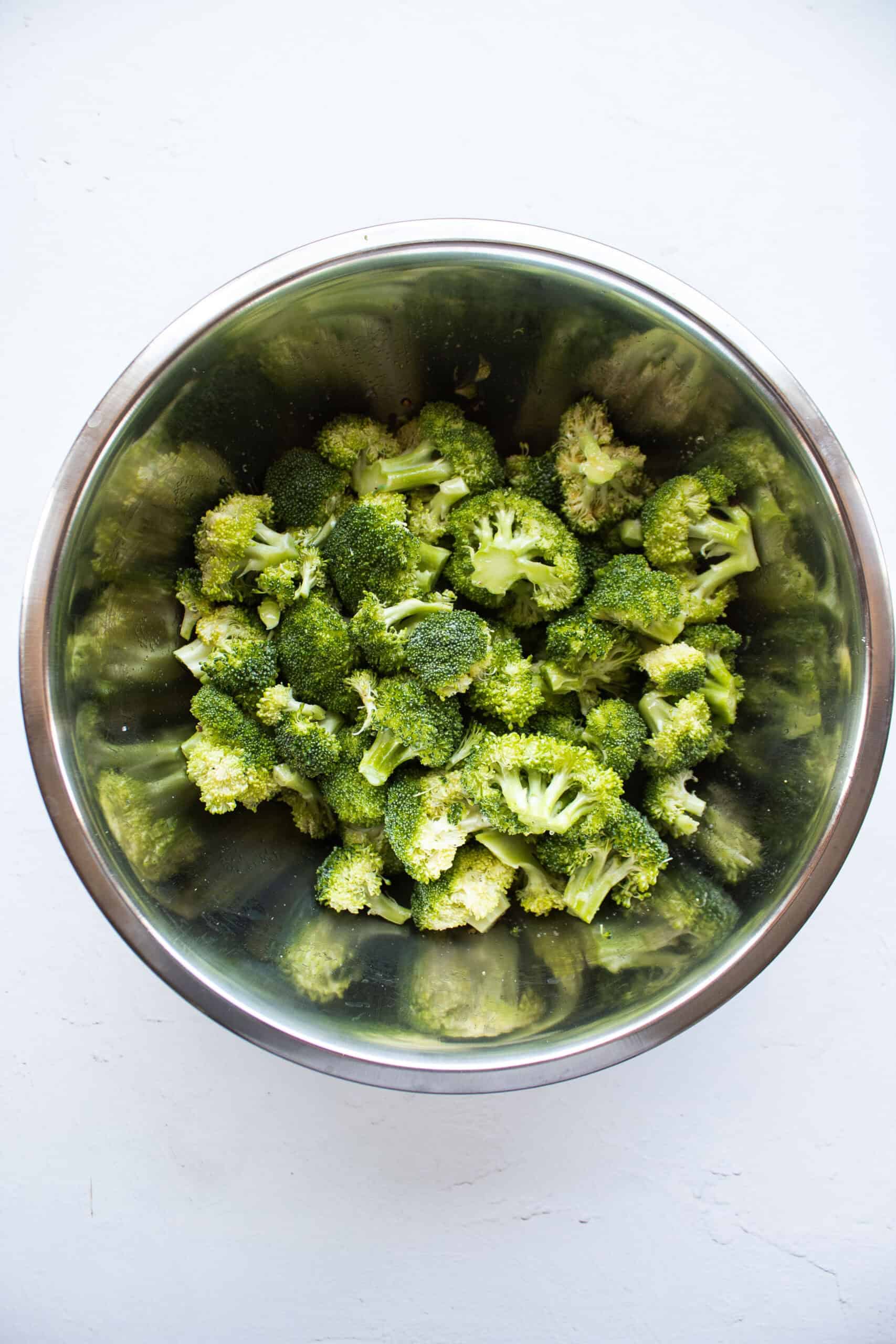 Chopped broccoli florets seasoned with salt, pepper, garlic powder, and olive oil.