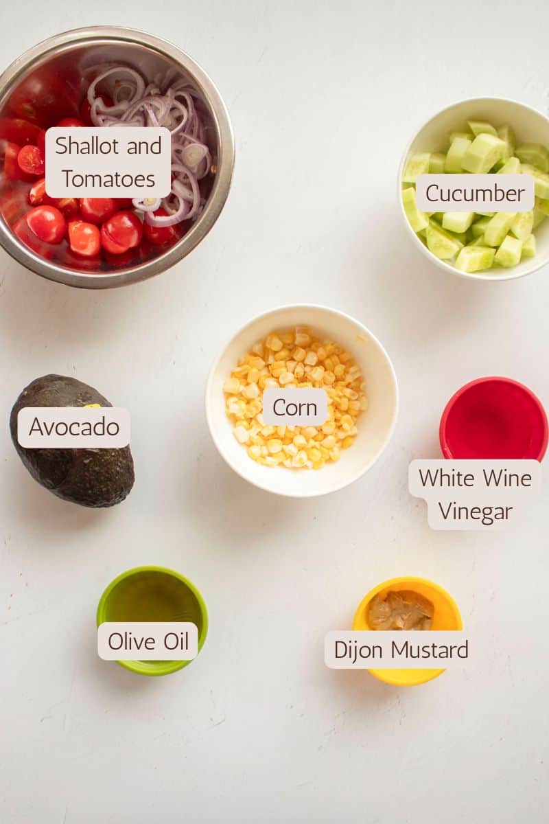 Ingredients to make a corn salad with avocado and tomatoes.