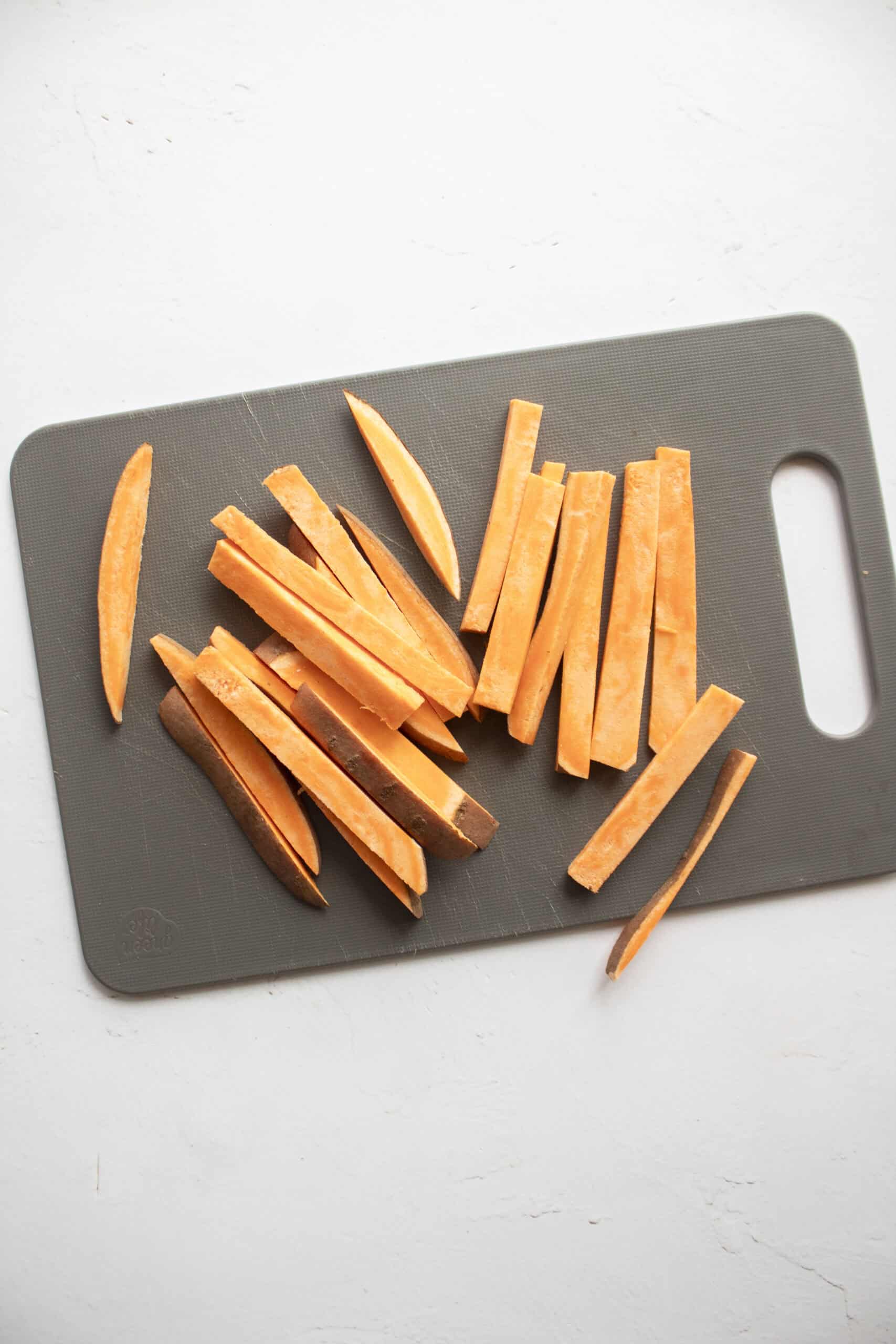 Sliced sweet potato into thin strips before adding olive oil.