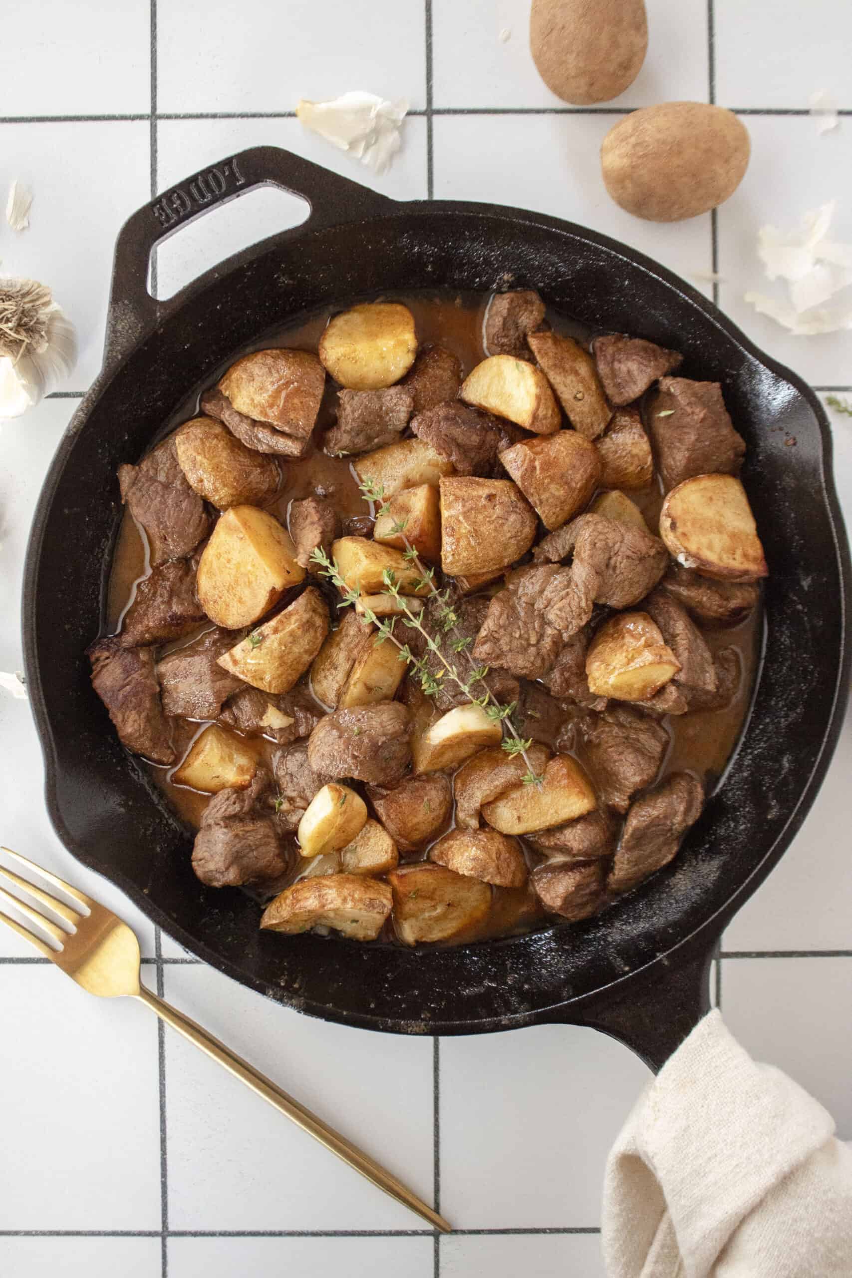 Cast iron garlic butter steak tips with air fried potatoes.
