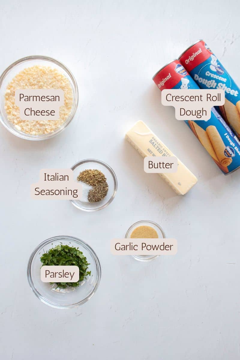 Ingredients to make garlic parmesan pull apart bread in a cast iron skillet.